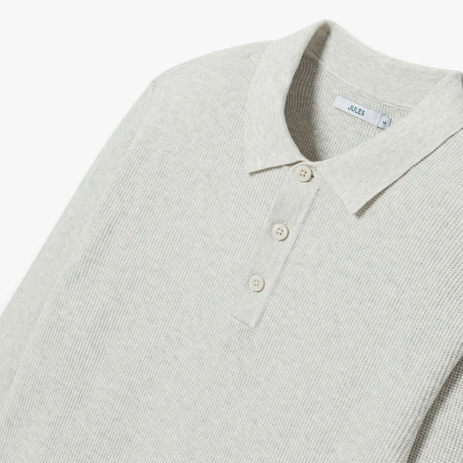 Polo met knopen in textuurstof